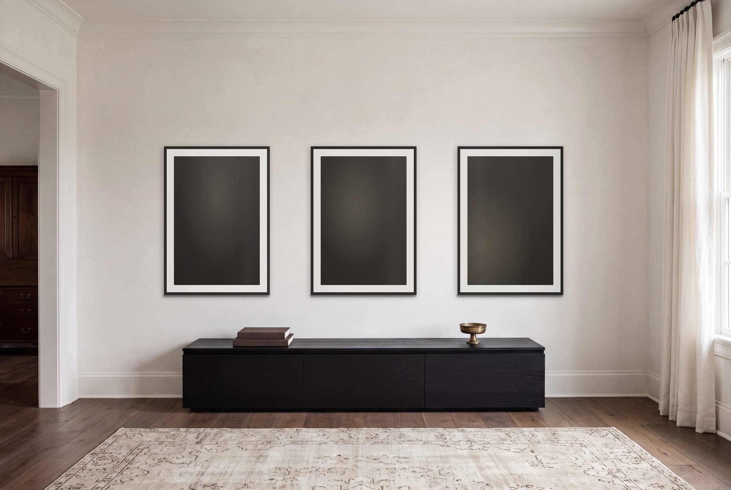 Three framed works from the collection hung together on one wall